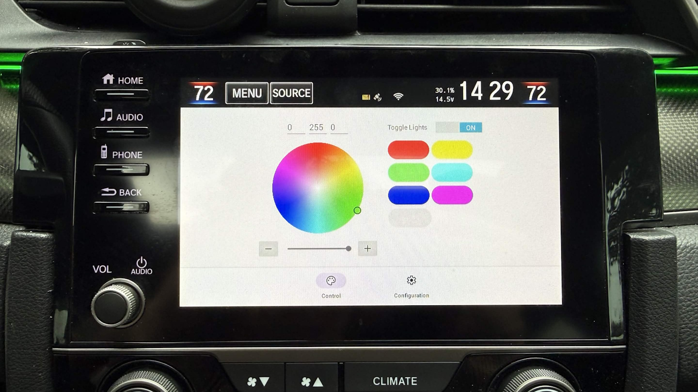 A user interface on a car's built-in touchscreen featuring a color selection wheel, six preset colors, a brightness adjustment wheel, and a light power toggle button.