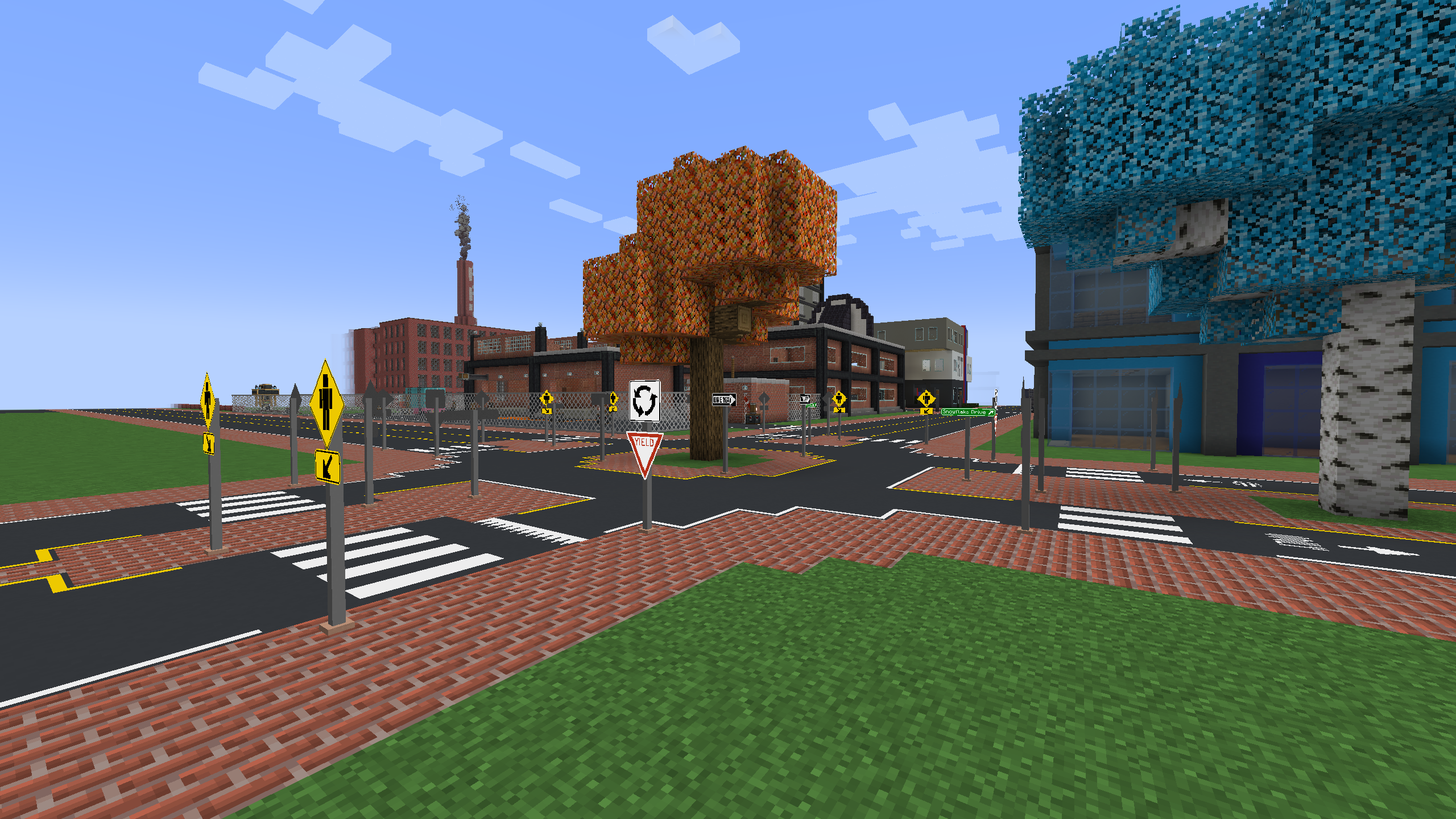 A roundabout with pedestrian crossings, and a decorative tree in the center.